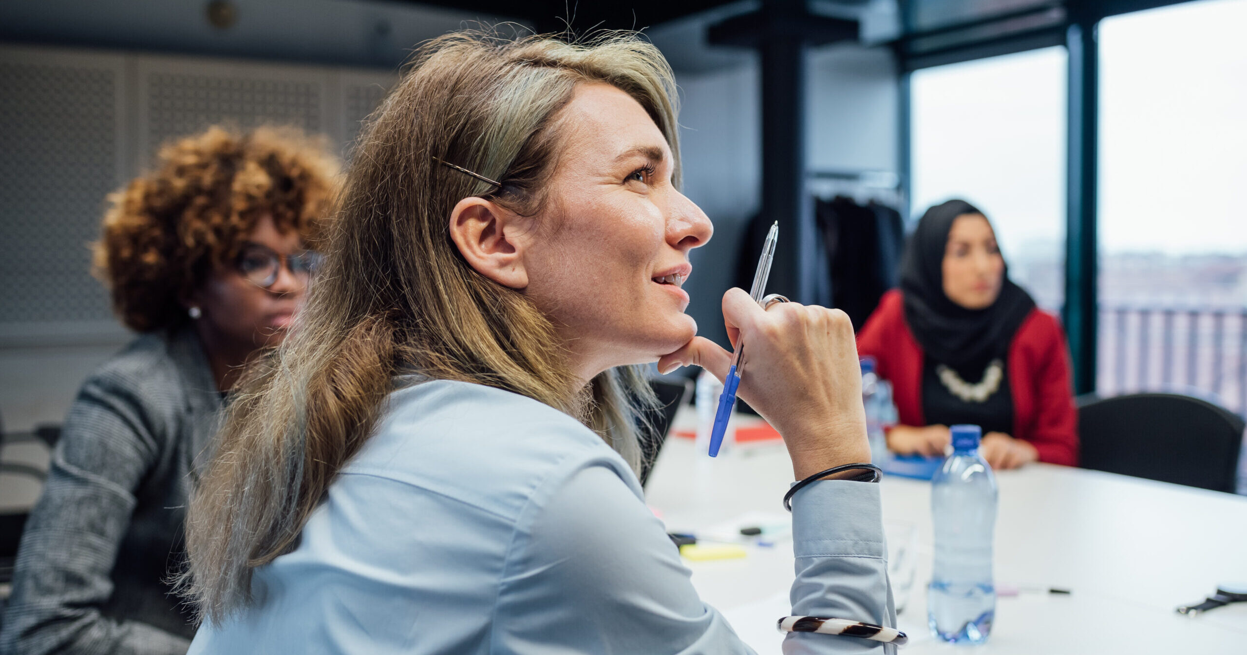 Diverse women brainstorming in a meeting at an office