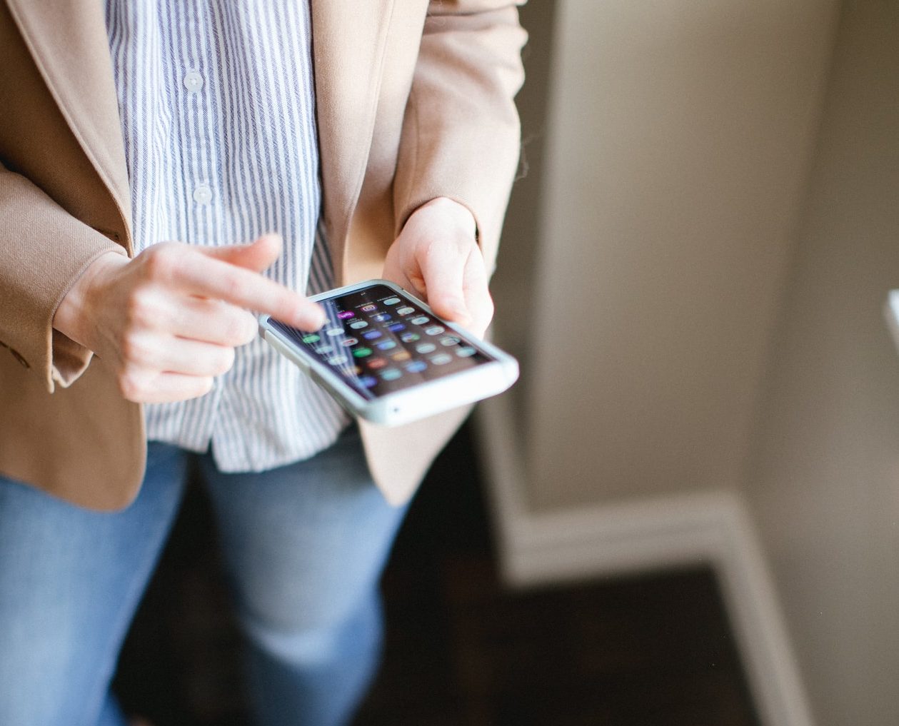 a young woman looks at her cell phone