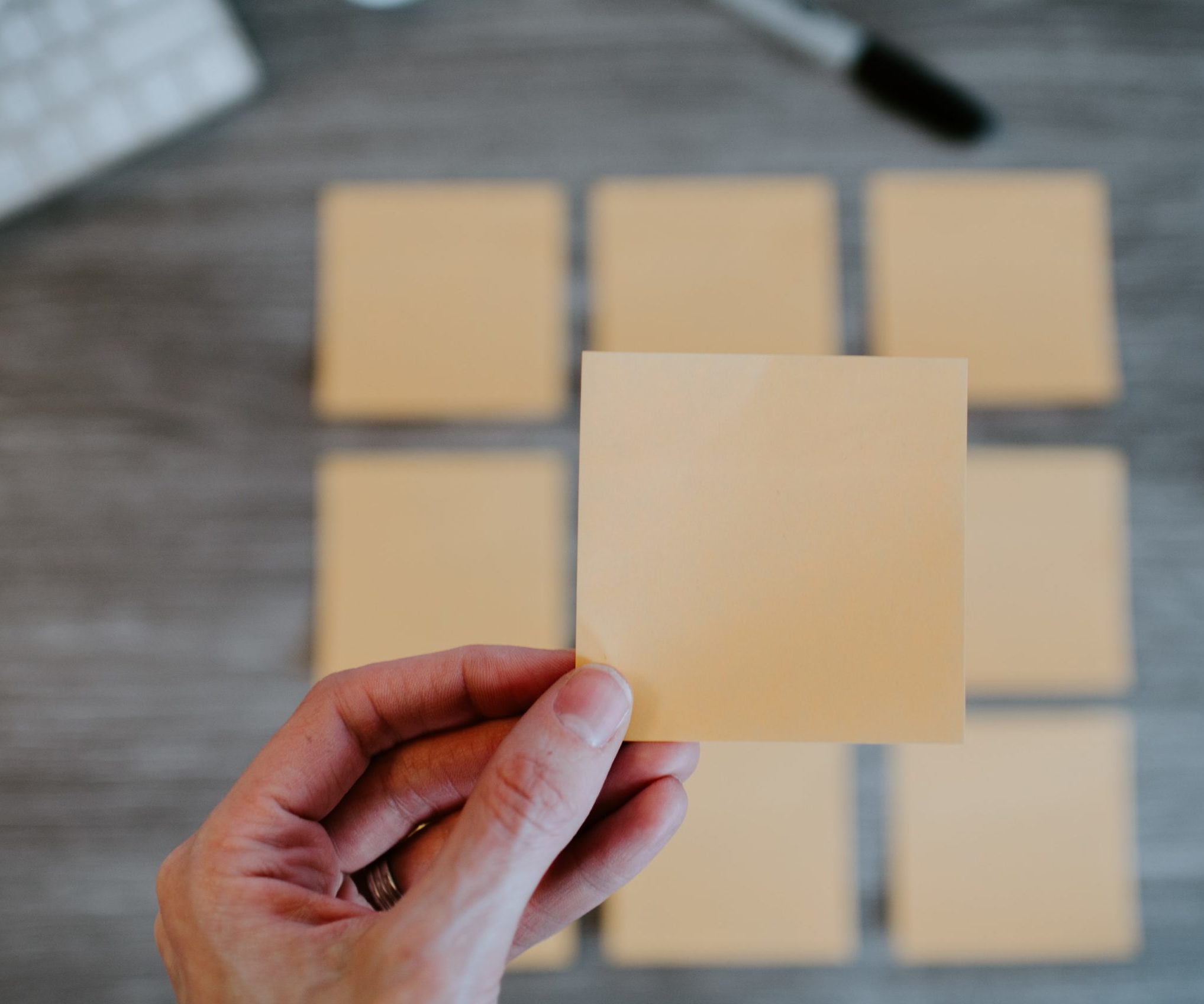 Woman holding sticky note.