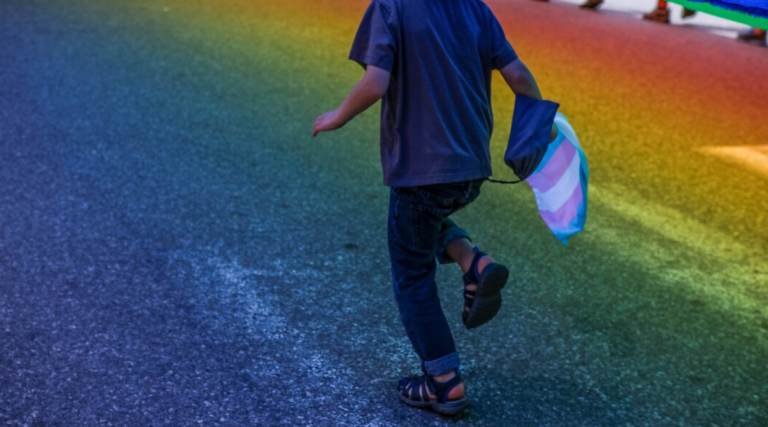 feet of child running on rainbow coloured street