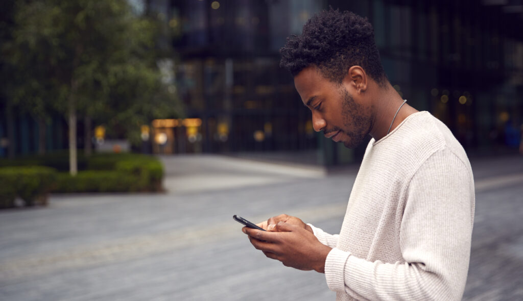 A man looking at this phone