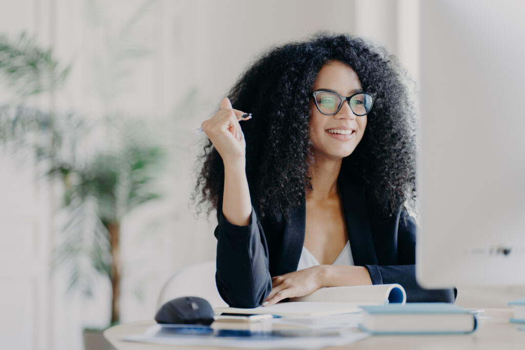 African American woman looks at computer screen