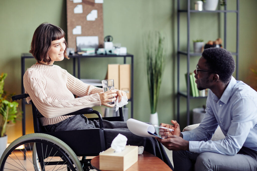 woman in a wheelchair talks to a man