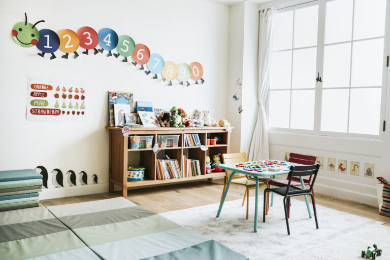 an early childhood education space wth a desk chair books and artwork on the wall