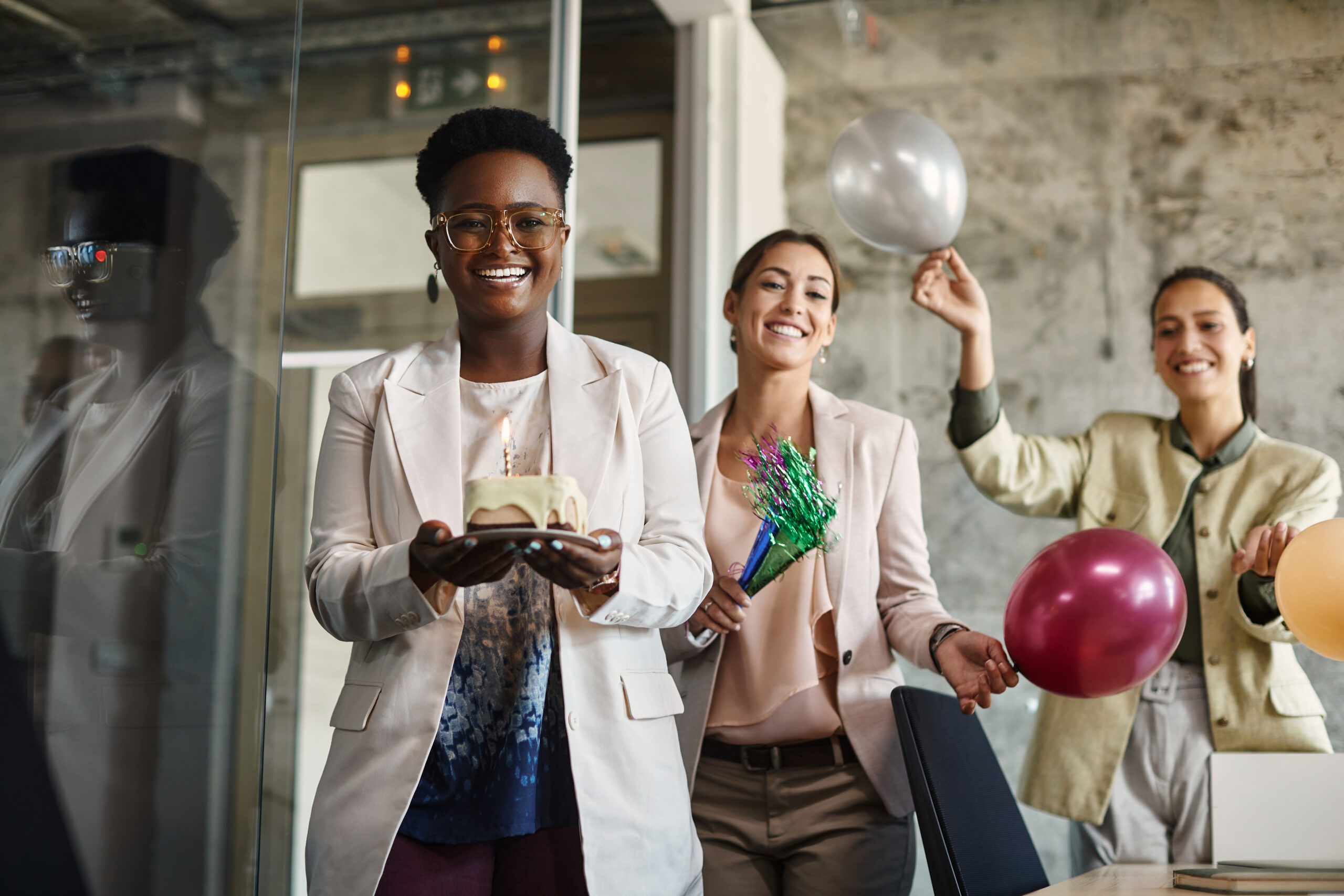 Black businesswoman and her female colleagues having fun on office party.