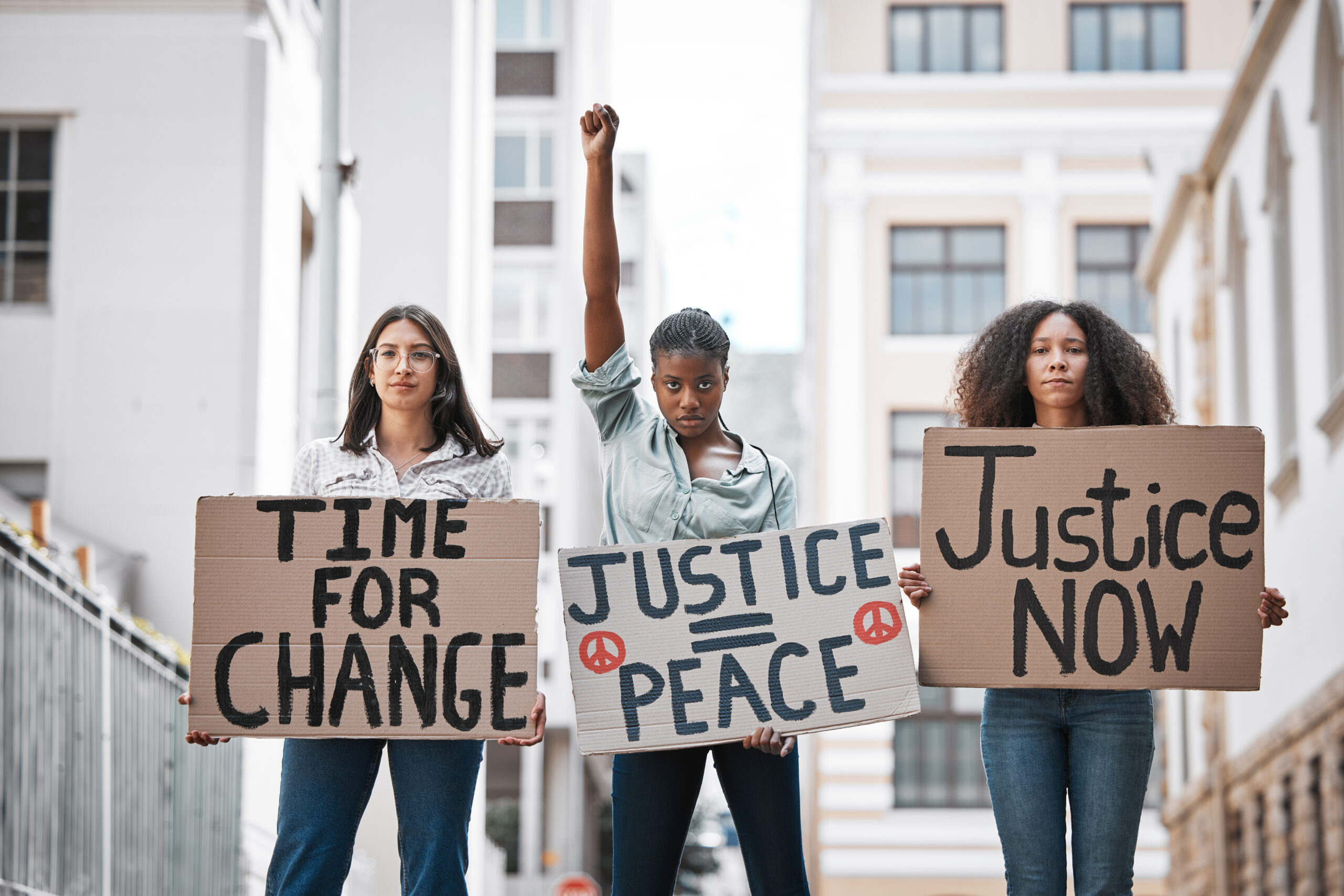 Women holding up protest signs