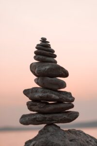 a tier of rocks in the shape of an inukshuk which is a form of a traditional Inuit Indigenous signage 