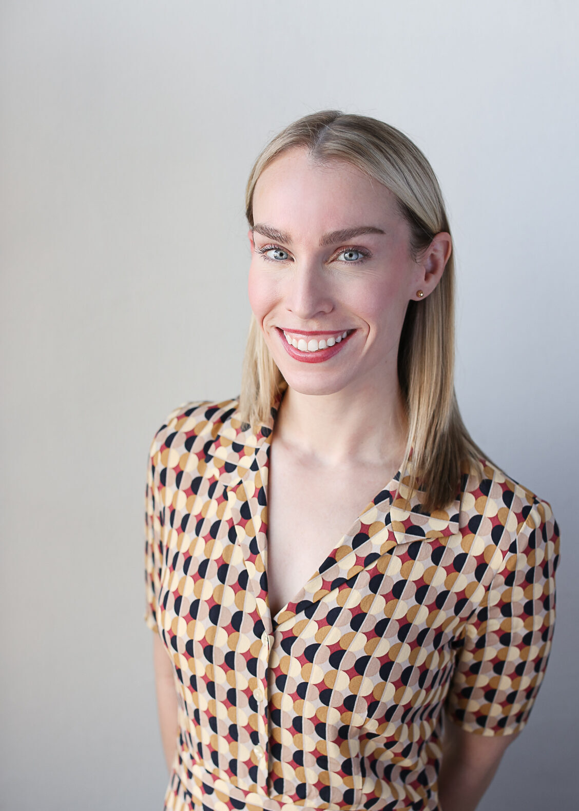 headshot of jen hazell with shoulder length blonde hair and vintage patterned dress