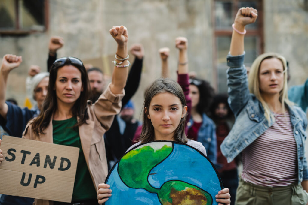 Group of activists with raised fists protesting on streets.